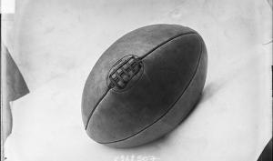 Photographie de presse datée de 1907, en noir et blanc, représentant un ballon de rugby, couture vers le haut.