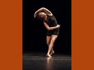 CPhotographie de Camille Desmarest en train de danser, elle porte un ensemble noir.