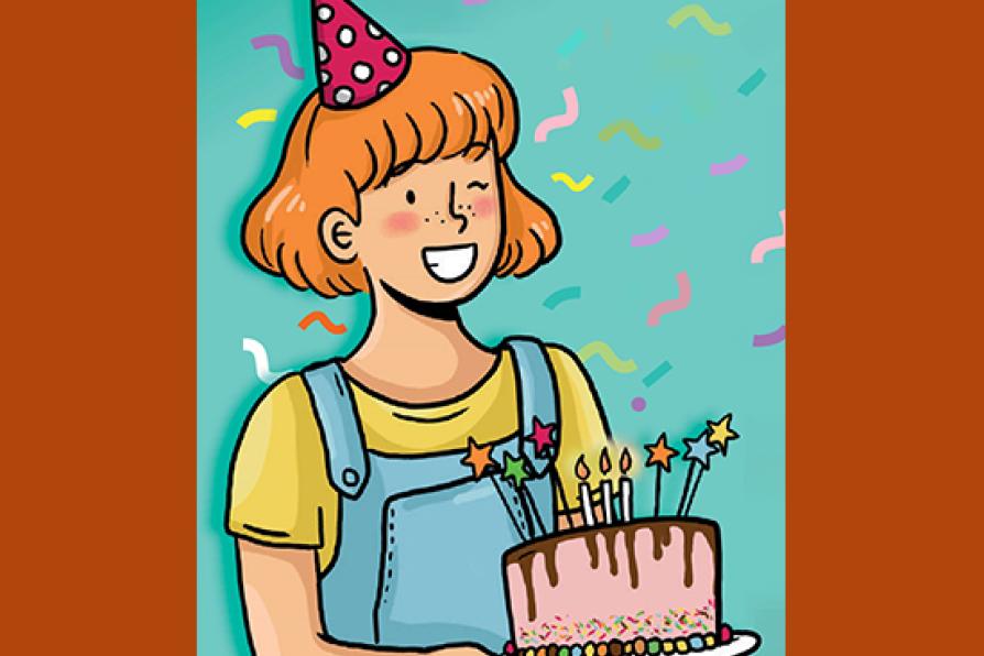 Une petite fille souriante tien gâteau d'anniversaire devant elle